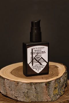 A 1 oz bottle of cedar & cinnamon beard oil by kühn products.