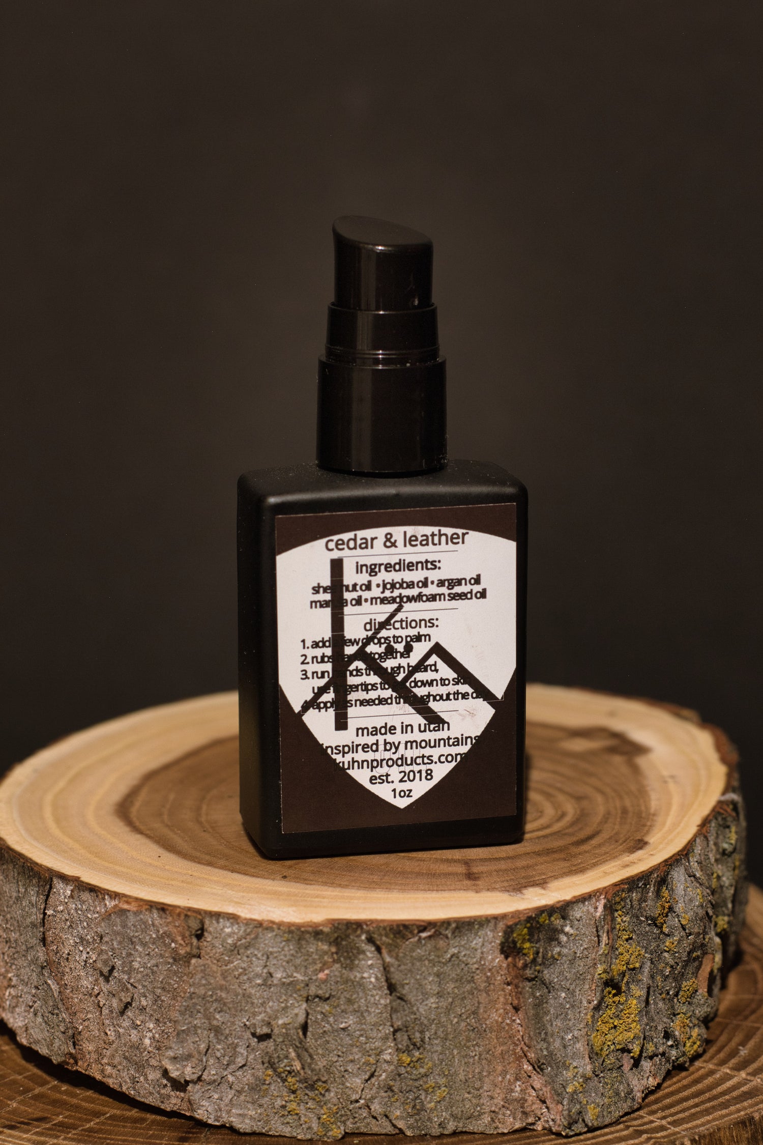 A 1 oz bottle of cedar & leather beard oil by kühn products.