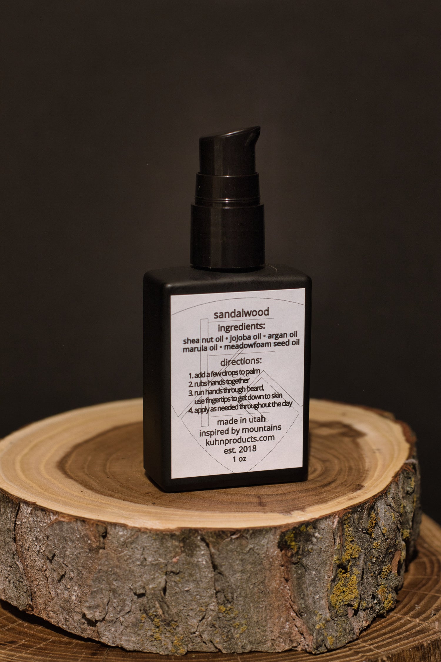 A 1 oz bottle of sandalwood beard oil by kühn products.