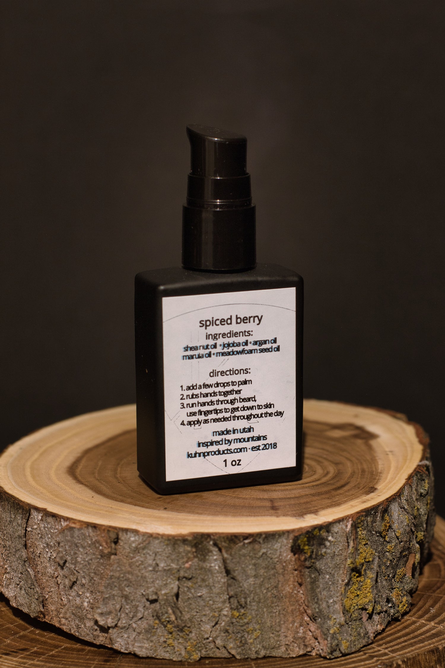 A 1 oz bottle of spiced berry beard oil by kühn products.