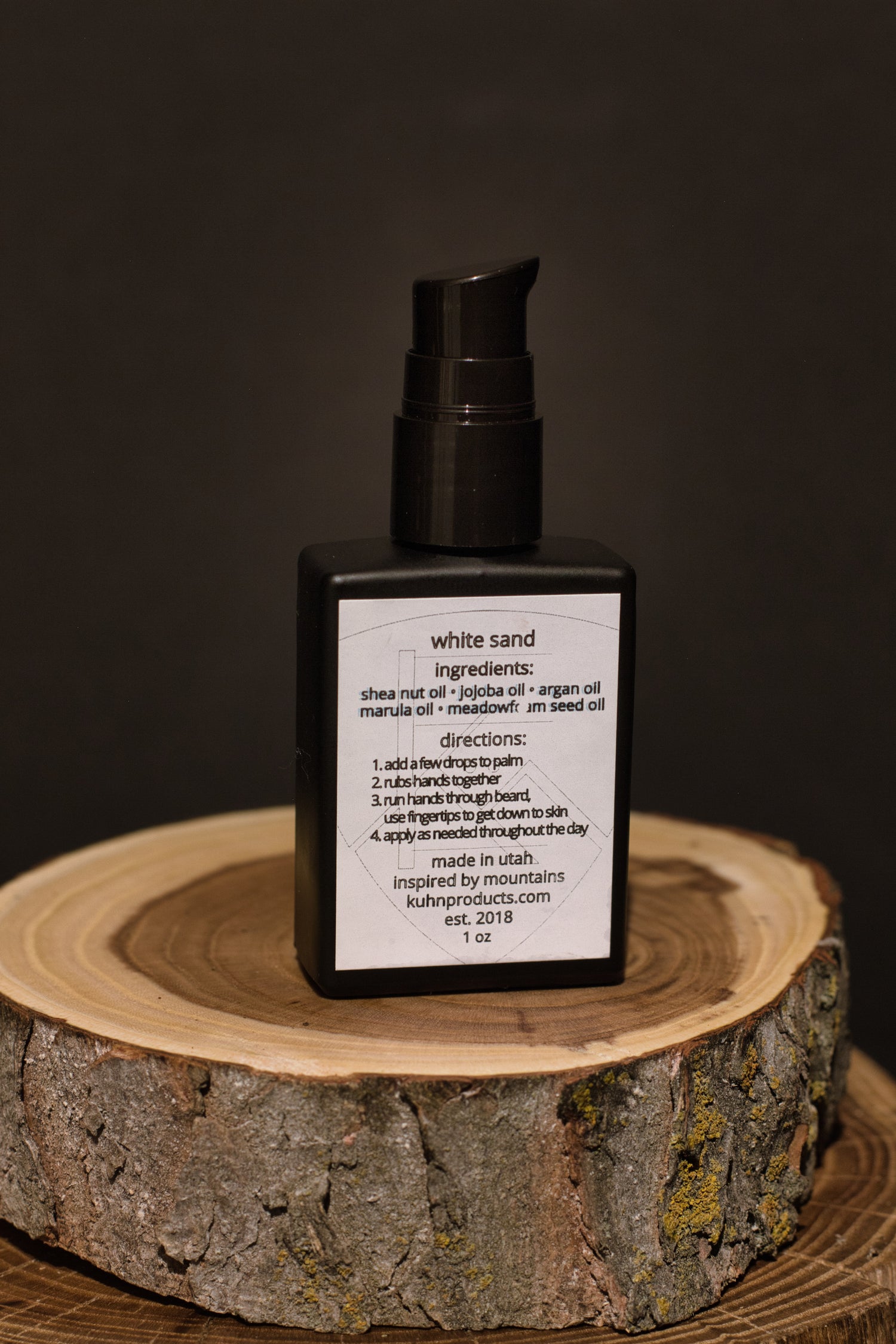 A 1 oz bottle of white sand beard oil by kühn products.