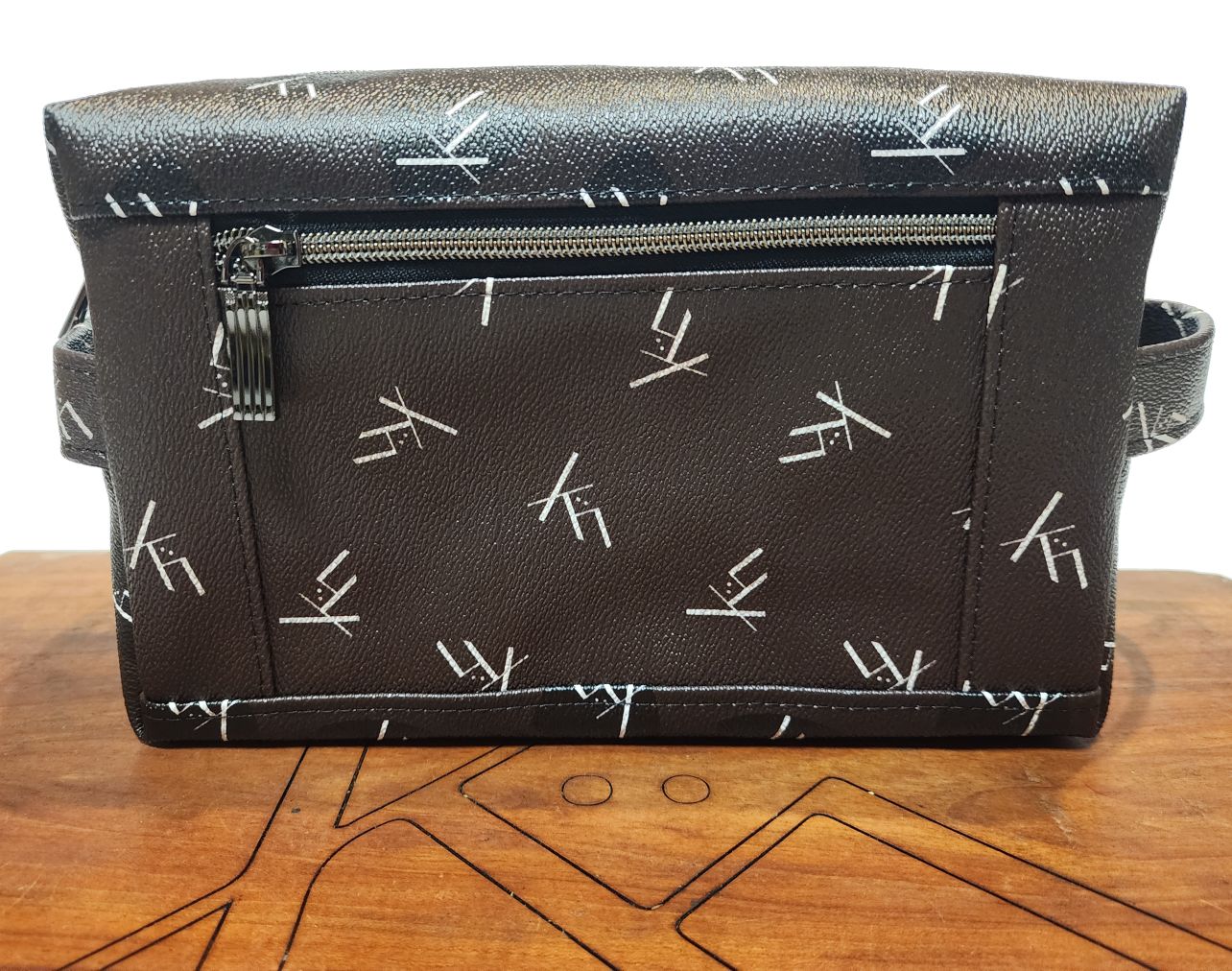 Toiletry bag dopp kit from kühn products dark brown with white logo.
