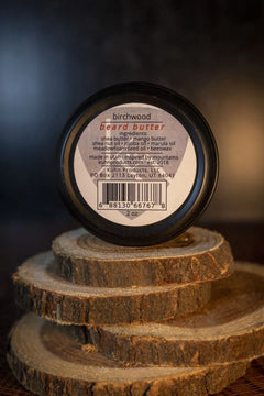 A 2oz tin of birchwood beard butter by kühn products.