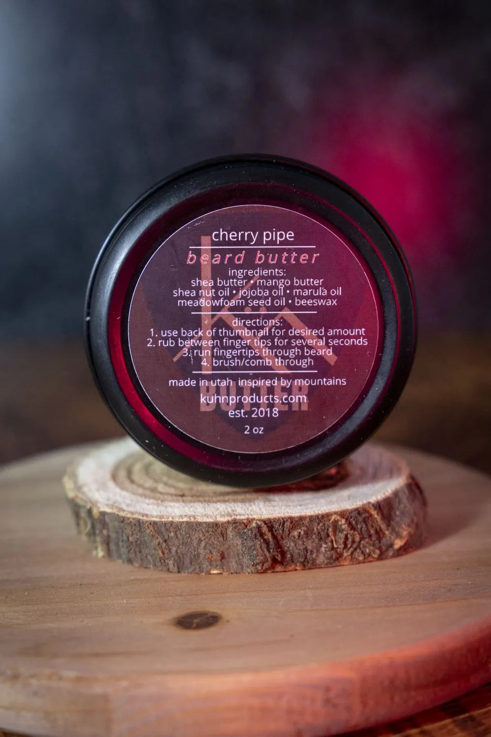 A 2oz tin of cherry pipe beard butter by kühn products.