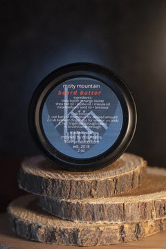 A 2oz tin of misty mountain beard butter by kühn products.