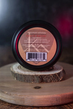 A 2oz tin of mountain whiskey beard butter by kühn products.