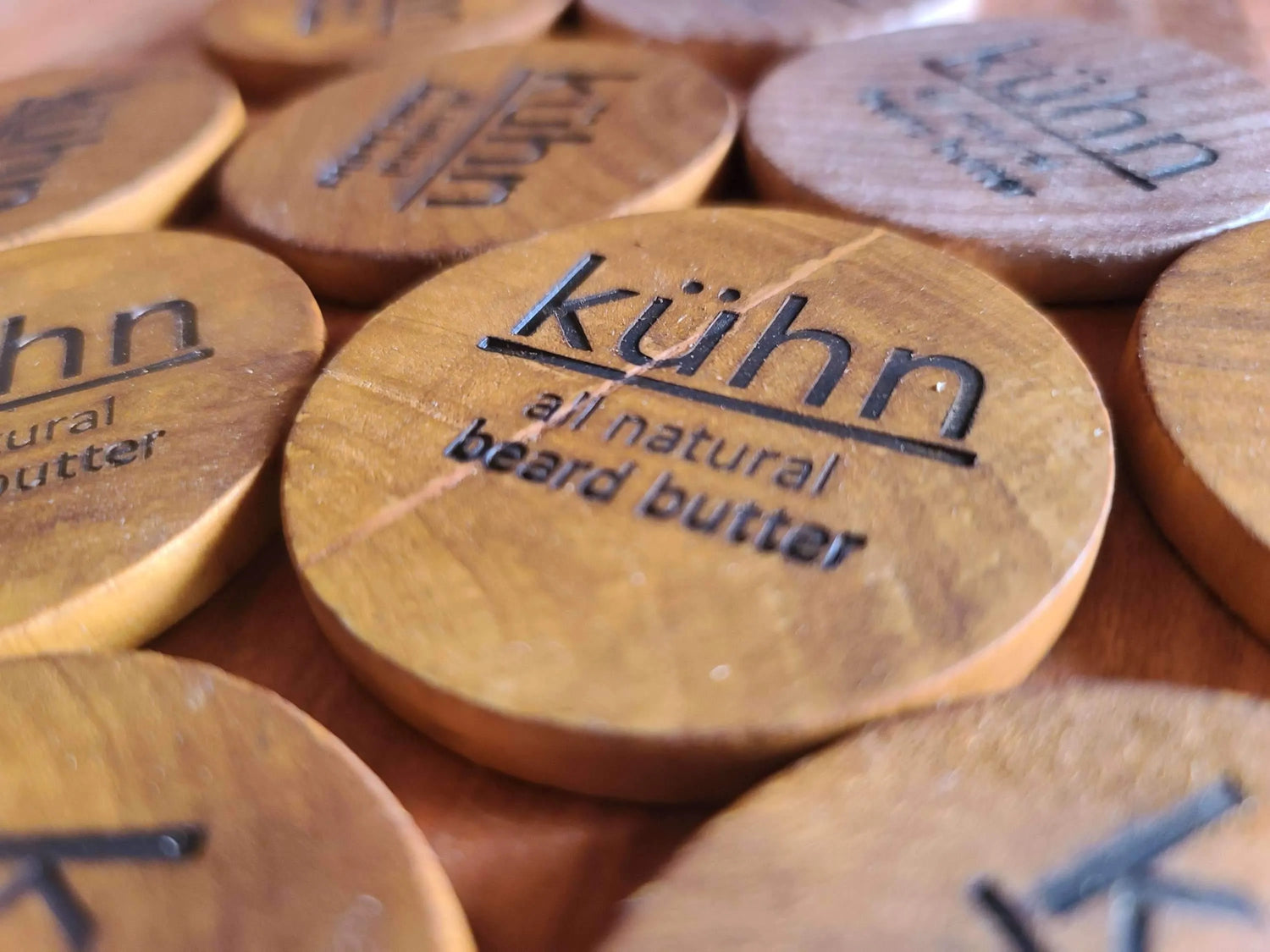 A bunch of beard butter wooden labels by kühn products.